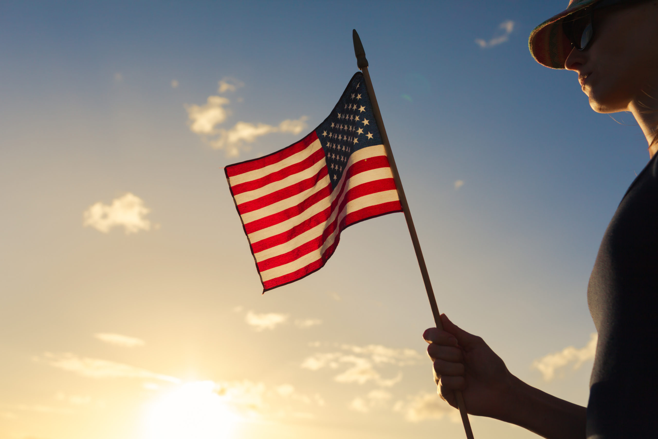 Woman holding a American flag.